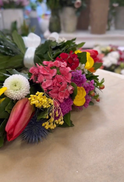 Esempio di corona d’alloro con fiori freschi di stagione